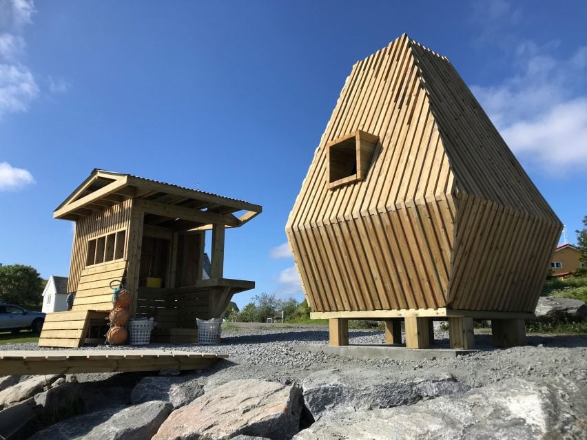 A photograph of two wooden panelled huts.