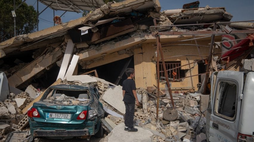 A boy looking at a house damaged in an Israeli strike in Hanine, southern Lebanon