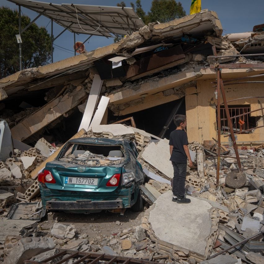 A boy looking at a house damaged in an Israeli strike in Hanine, southern Lebanon