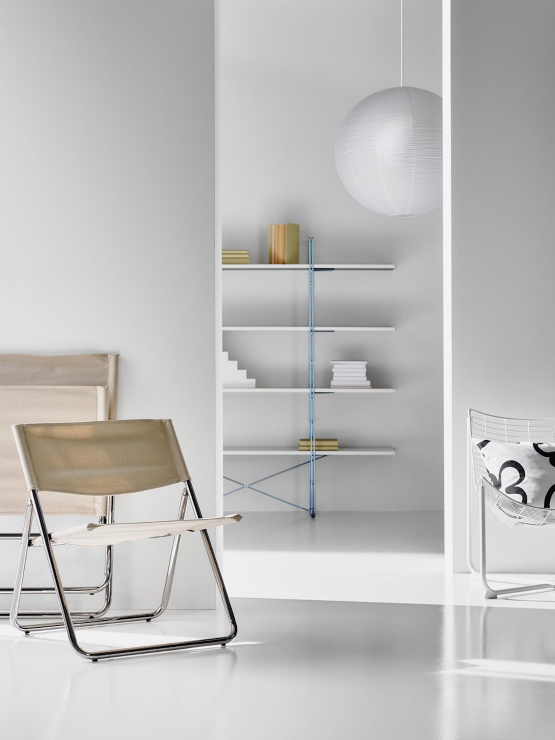 Photo of IKEA's Mofalla/Cox chair, with the Guide/Enteri/Byakorre shelf half visible behind a wall in the background