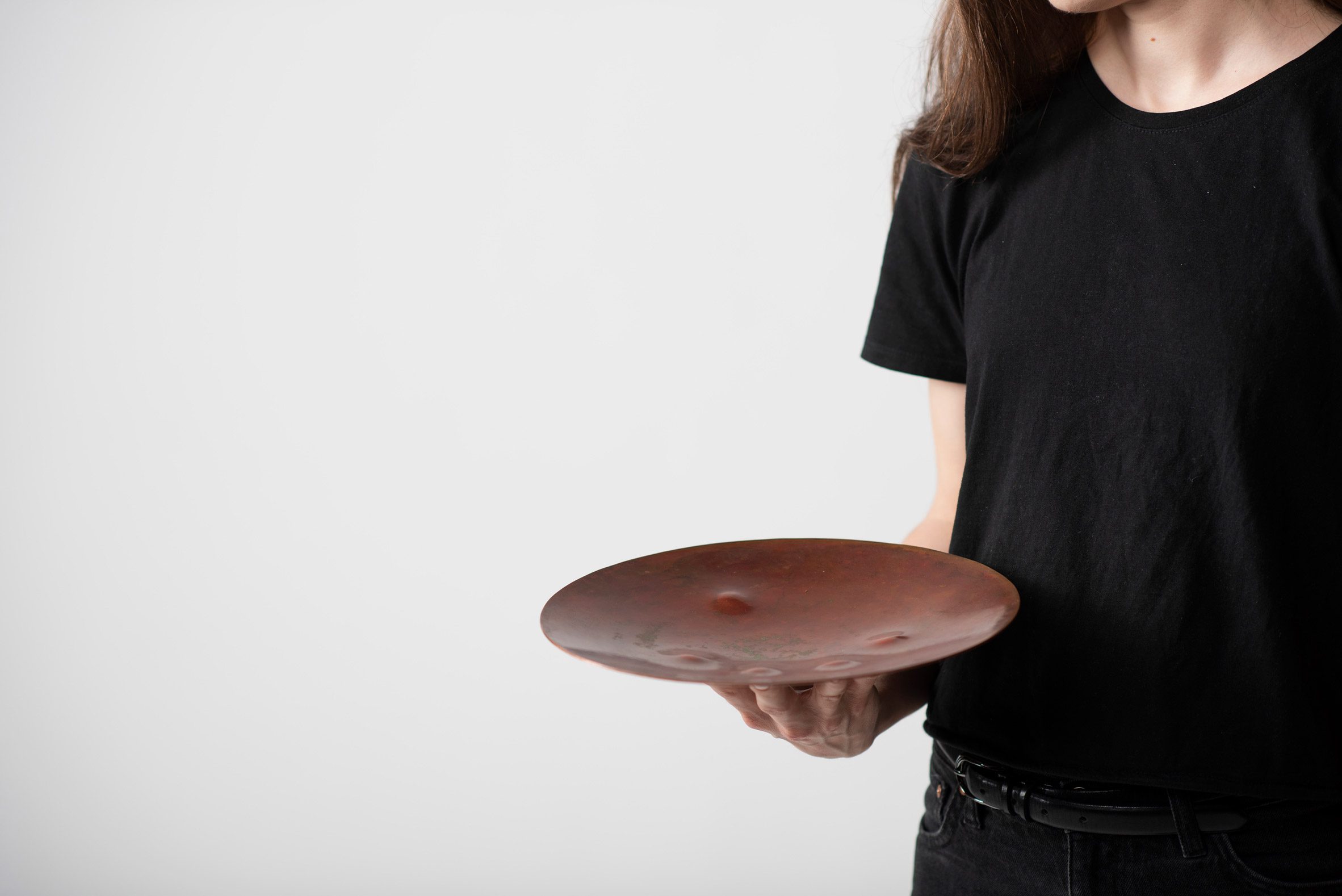 A photograph of a person holding a red plate.