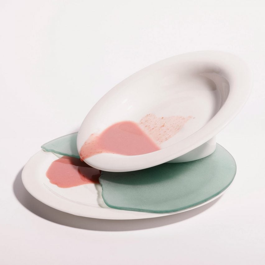 A photograph of a white dish with pink liquid coming out of it.