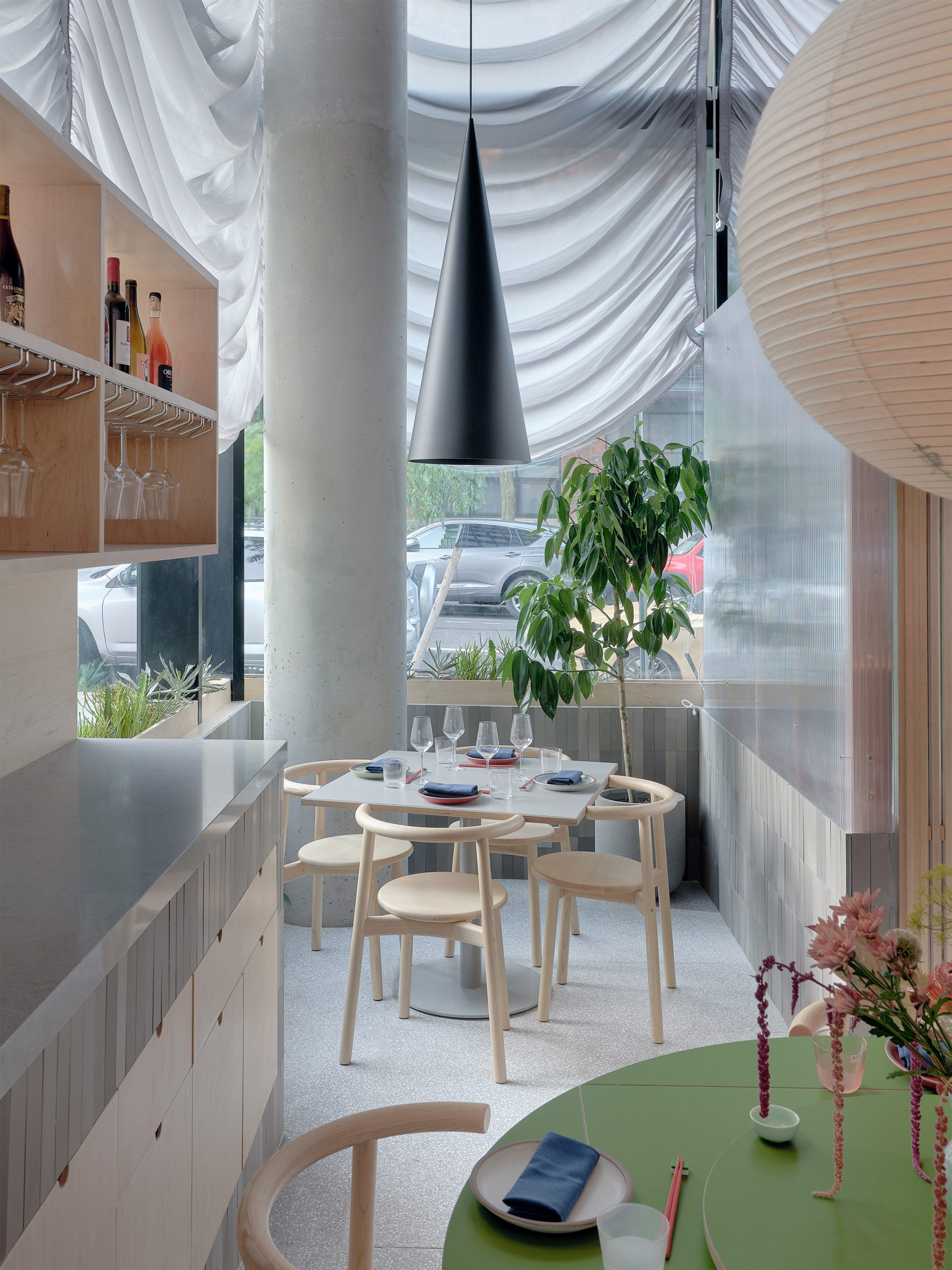 Corner of a restaurant with a small table beside a concrete column