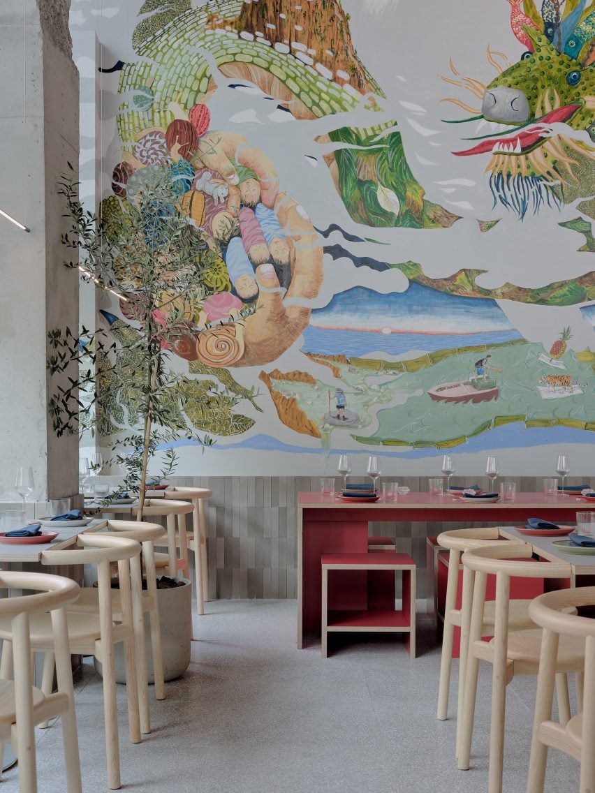 Restaurant with a large colourful mural across the back wall