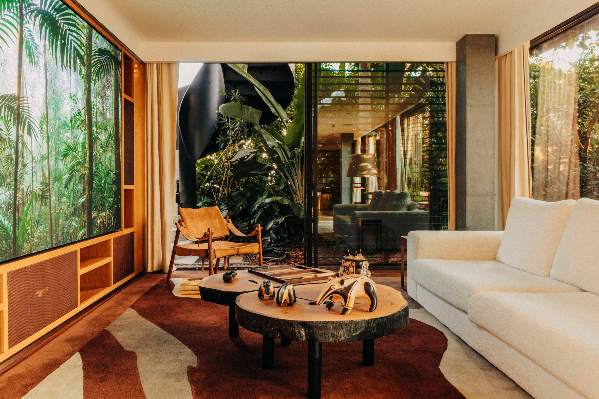 Den looking onto a terrace planted with tropical flora