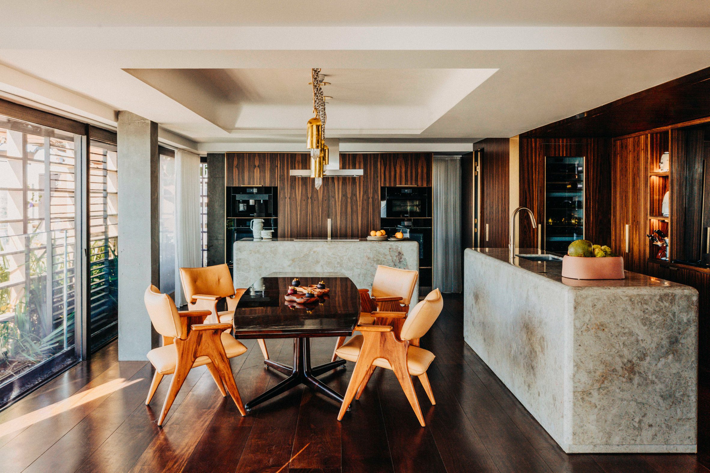 Kitchen featuring sculptural stone islands with curved corners