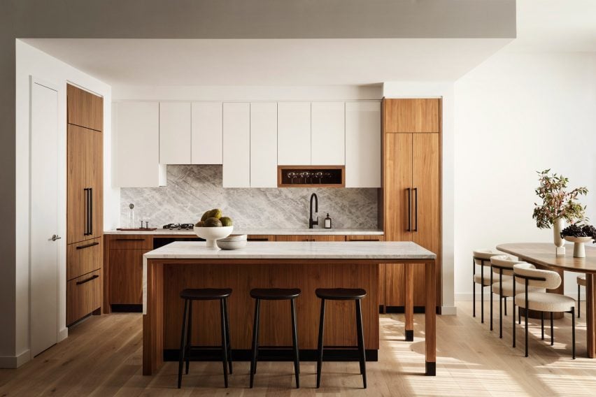 A kitchens featuring a Greek marble backsplash and waterfall island