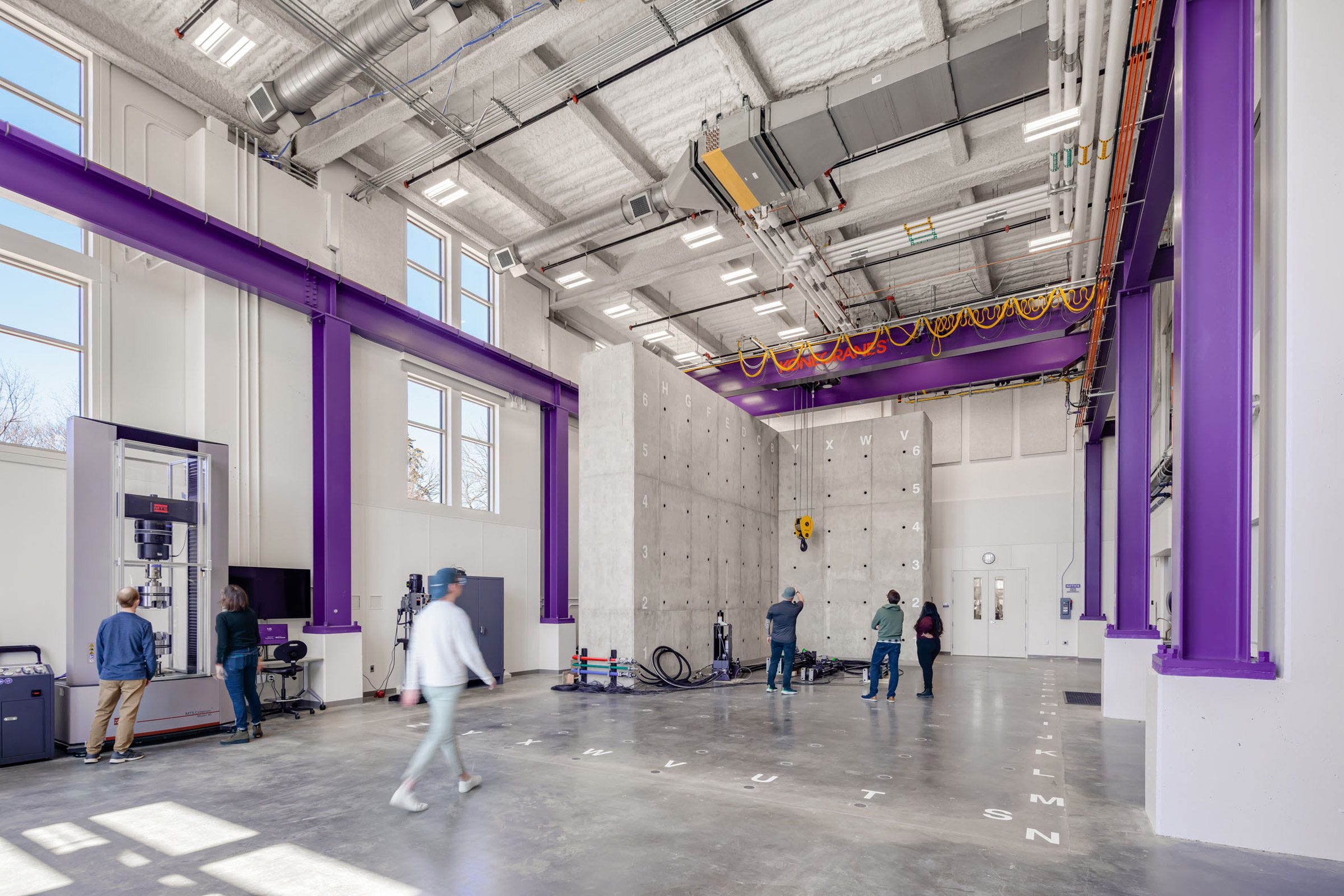 A high bay space featuring a concrete wall and a crane for engineering research and experiments