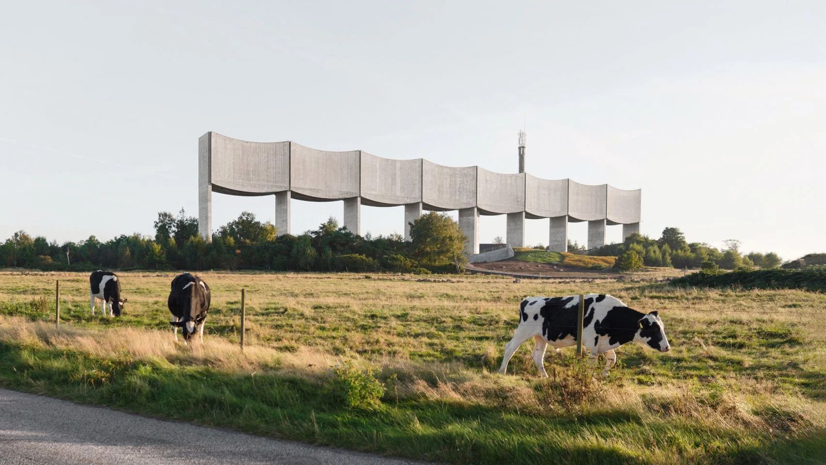 Sculptural water tower with cows grazing