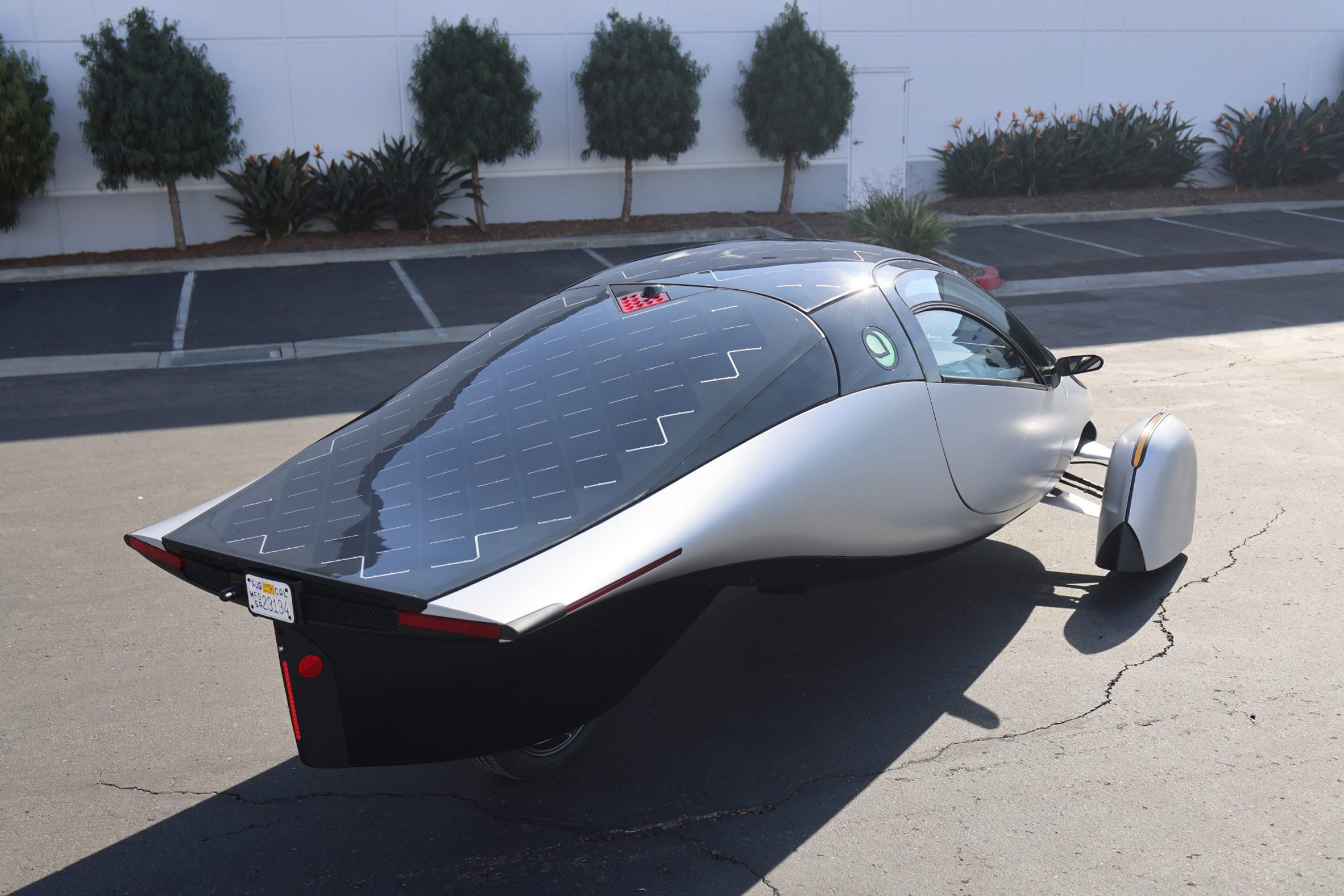 Photo of the rear of the Aptera solar electric vehicle showing sleek solar panels built into the hatch