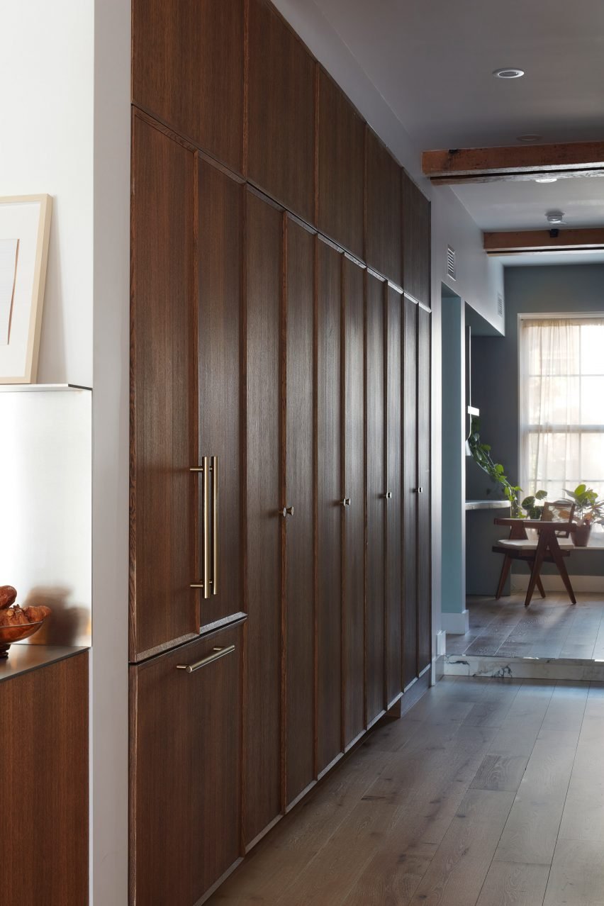 Hallway with tall wooden cabinetry