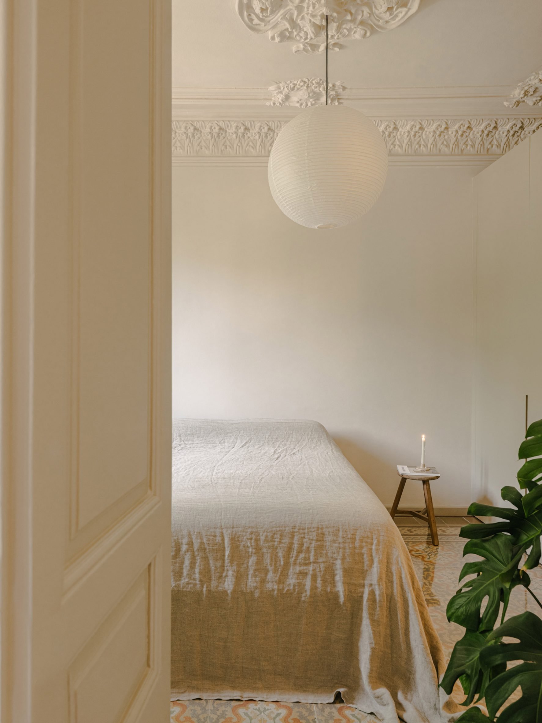 Bedroom with rice paper lamp and plant