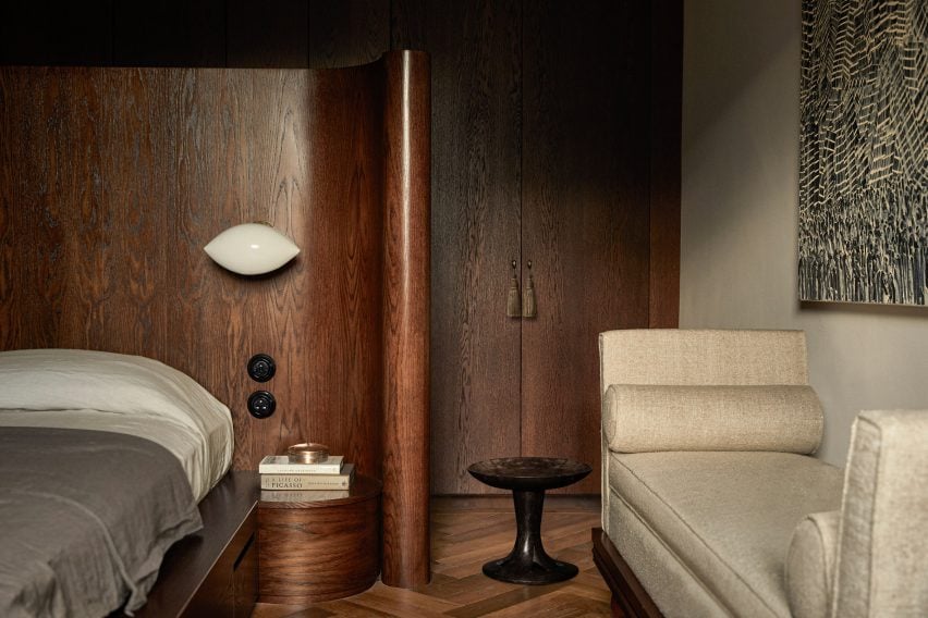 Curved wooden headboard in bedroom 