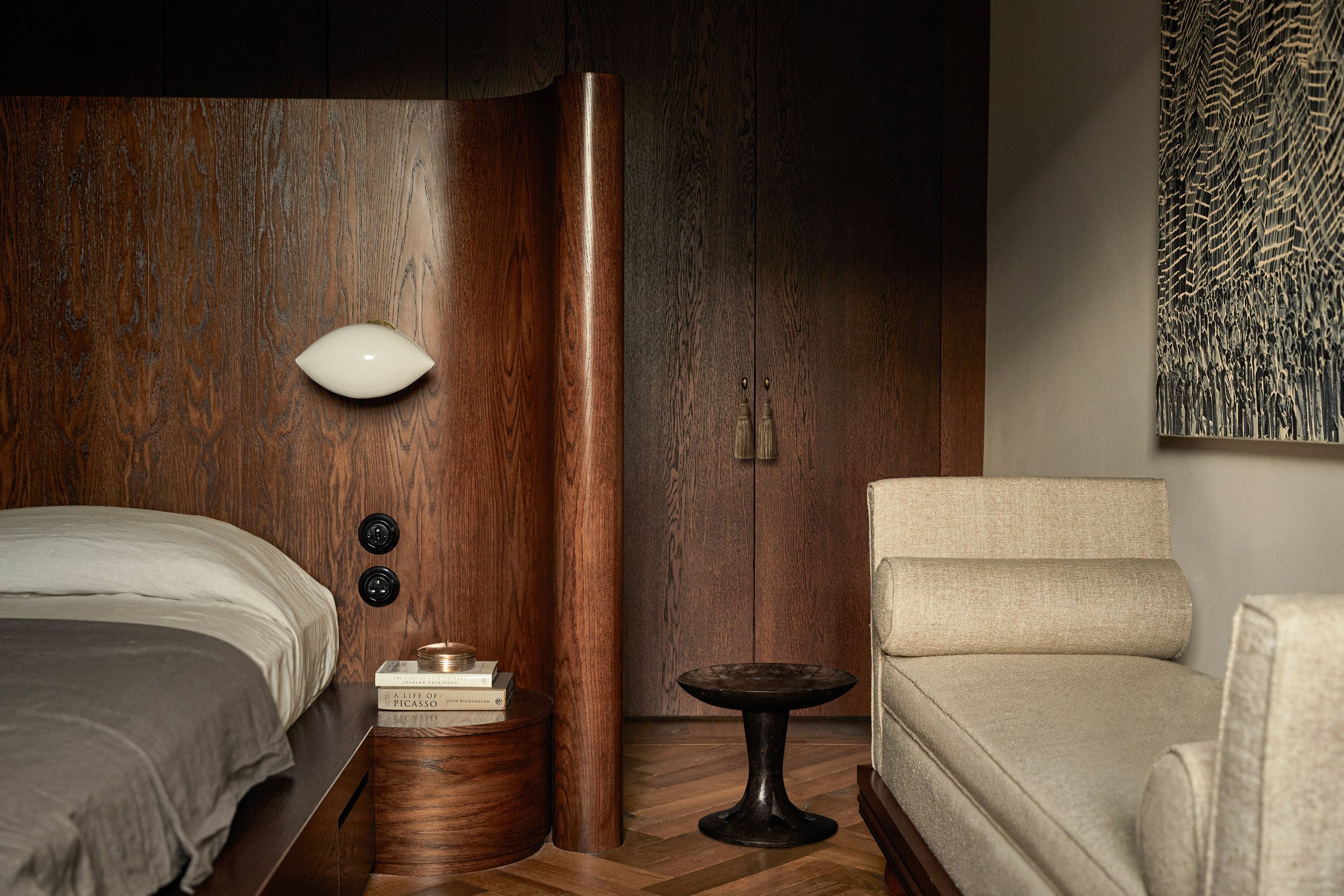 Curved wooden headboard in bedroom