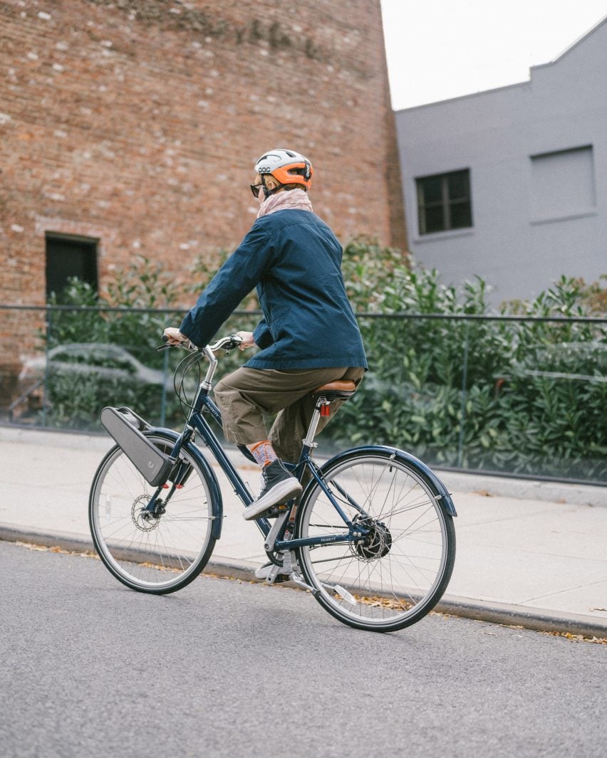 Person riding bike uphill with CLIP device