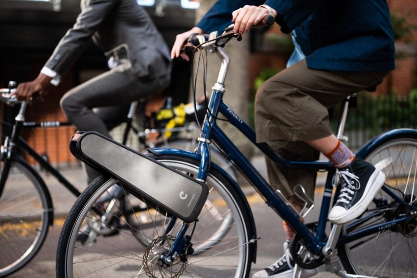 Person riding blue bike with CLIP attachment