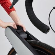 Person pulling lever on e-bike conversion attachment