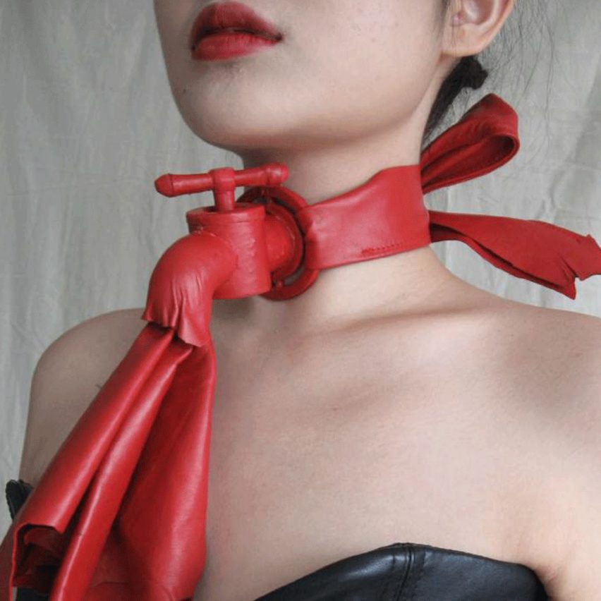 a person wearing a red fashion garment around their neck