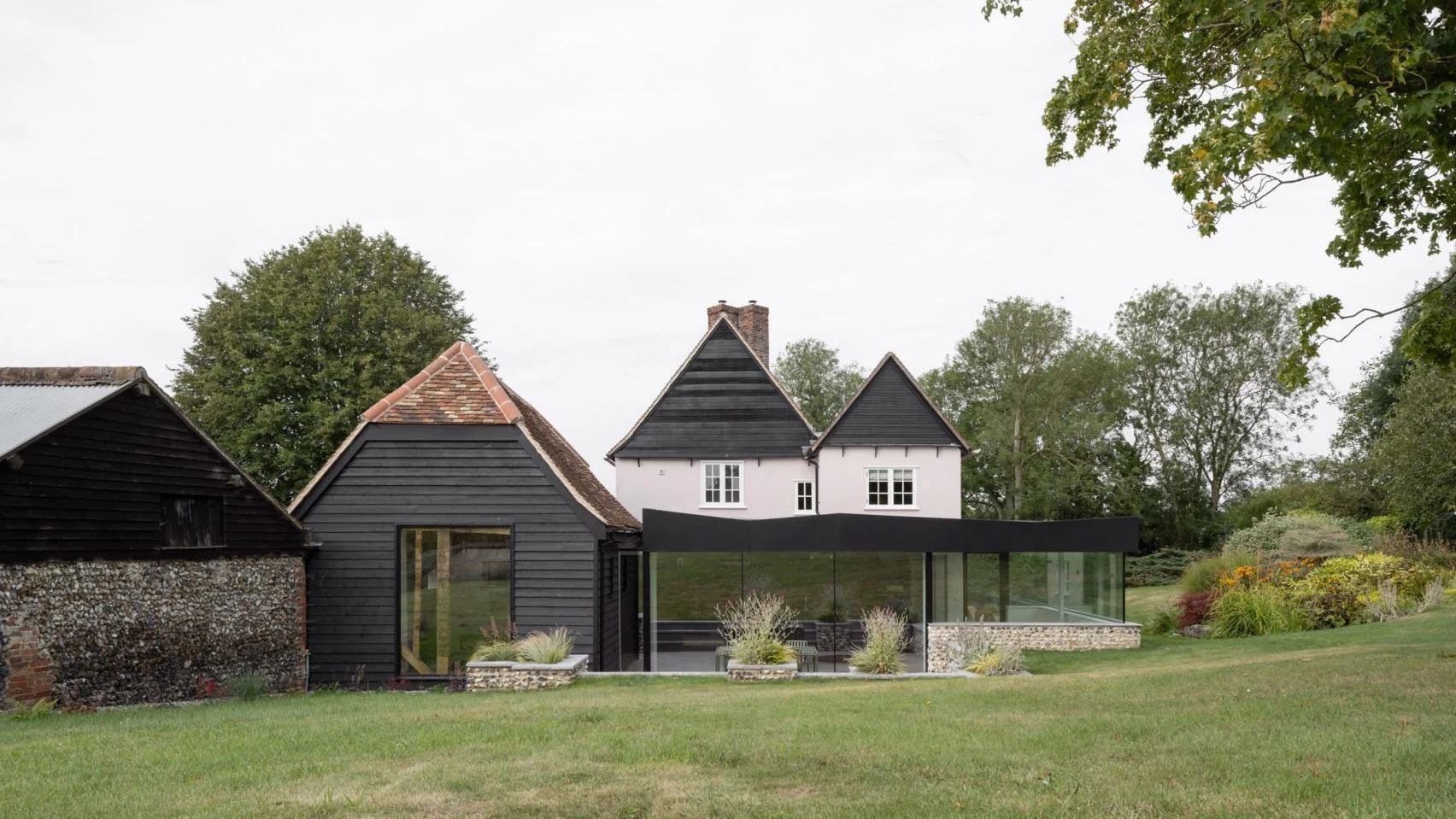 Old farm cottage with new black and glass extension