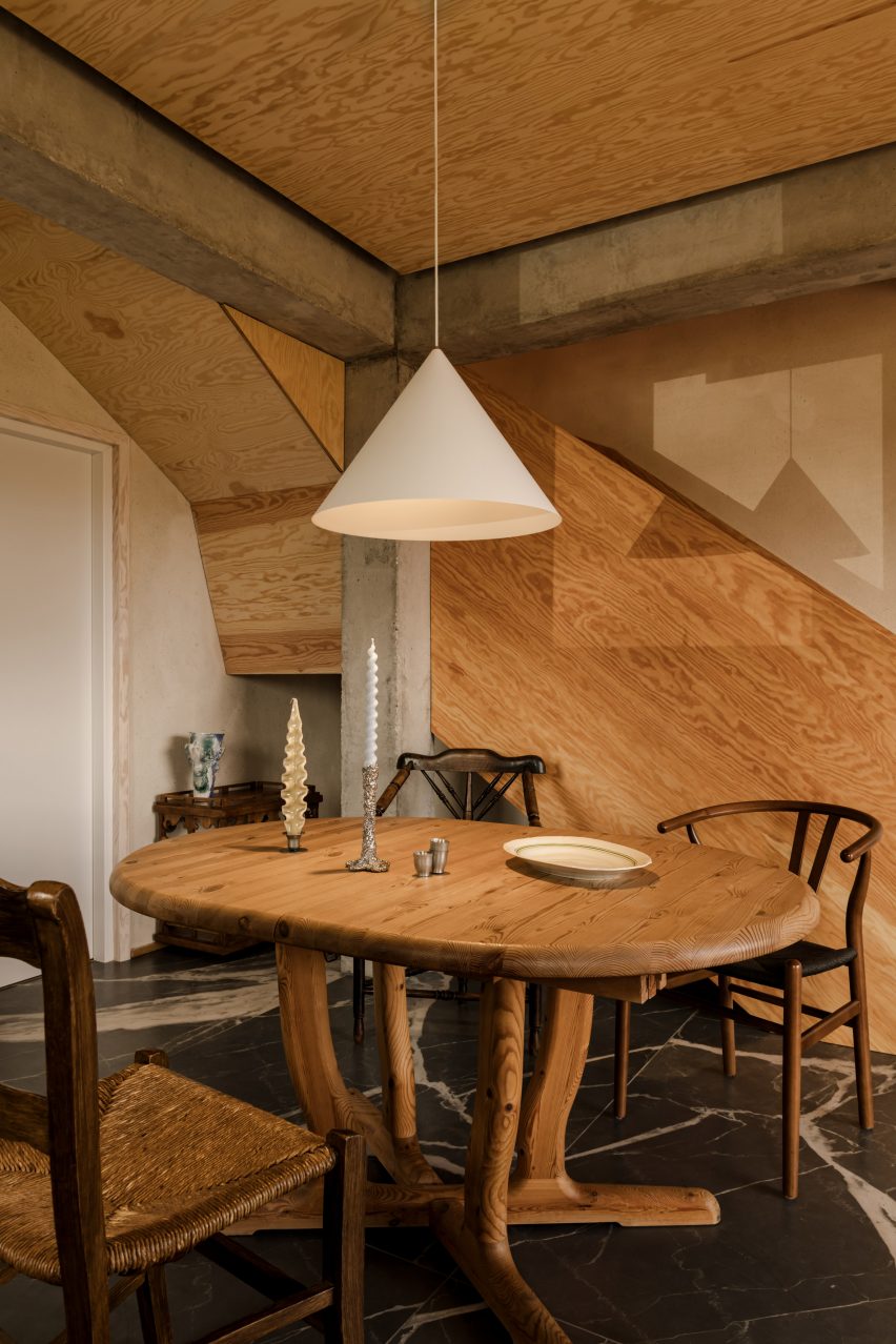 Veiny graphite flooring and a plywood staircase