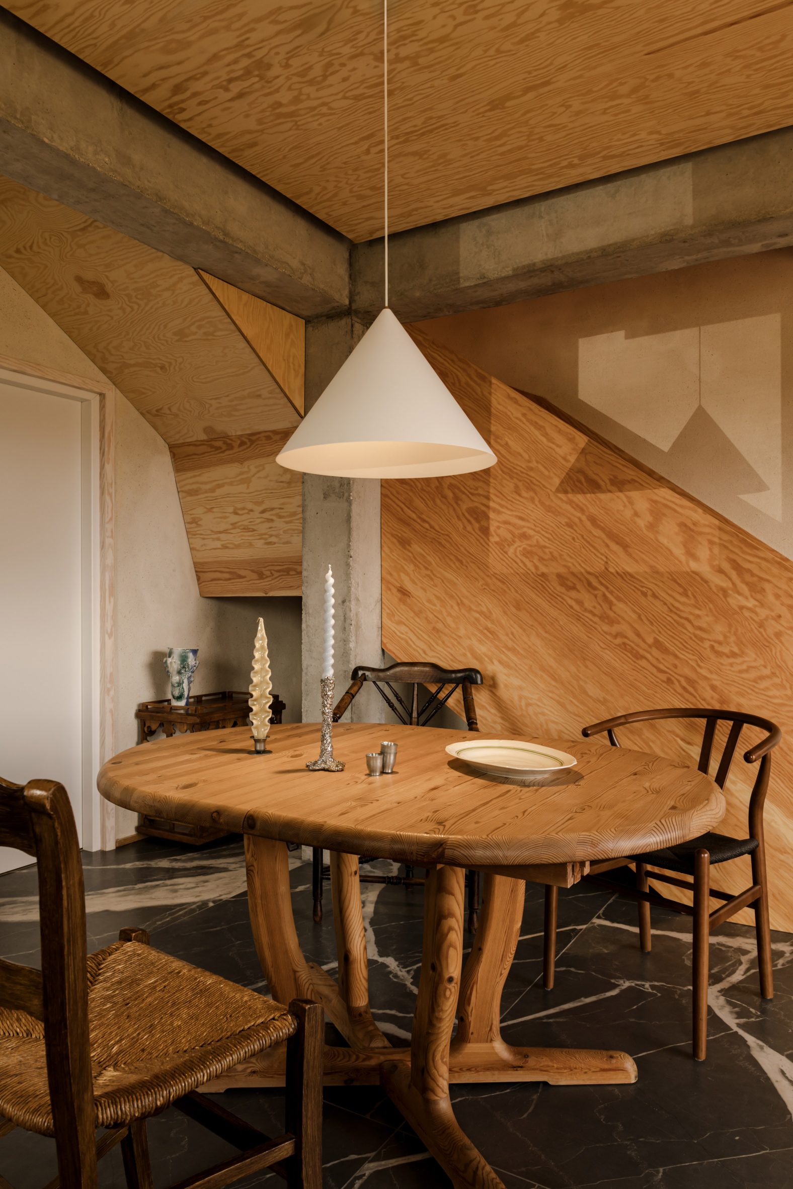 Veiny graphite flooring and a plywood staircase