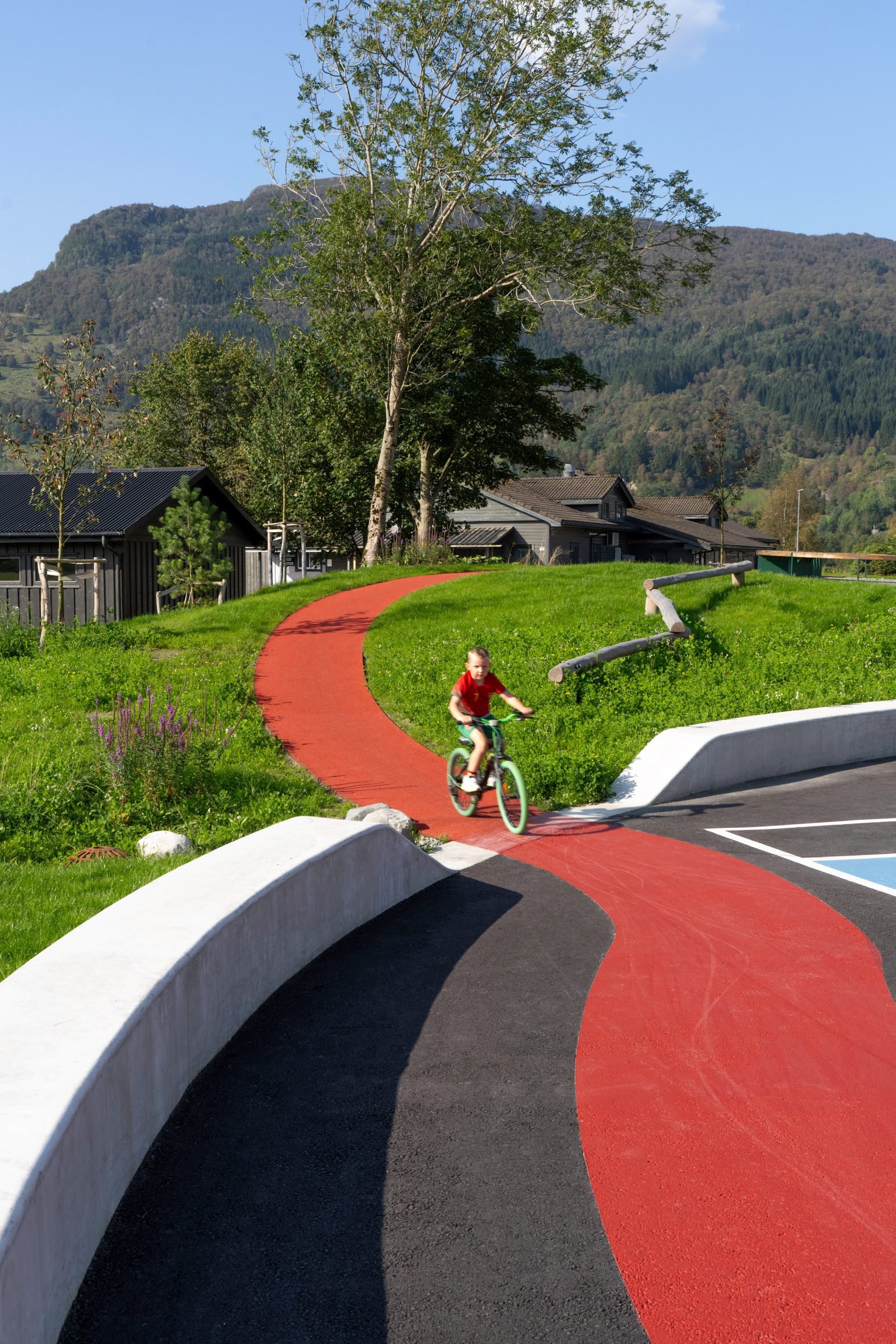 Red running track intersects the concrete bench