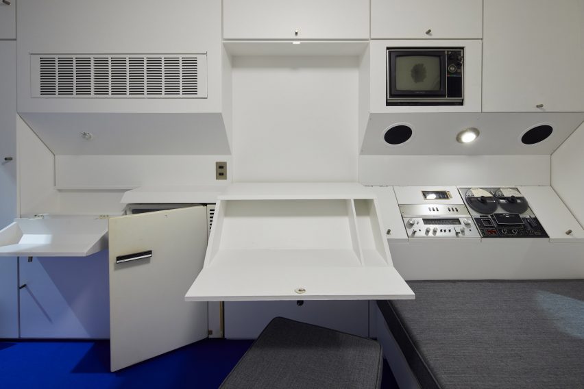 Living capsule with bed and fold out desk