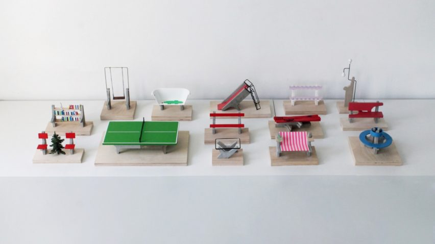 A photograph of multiple small-scale models of park and playground objects, including a table tennis table and slide. Each model is on a beige wooden plinth.