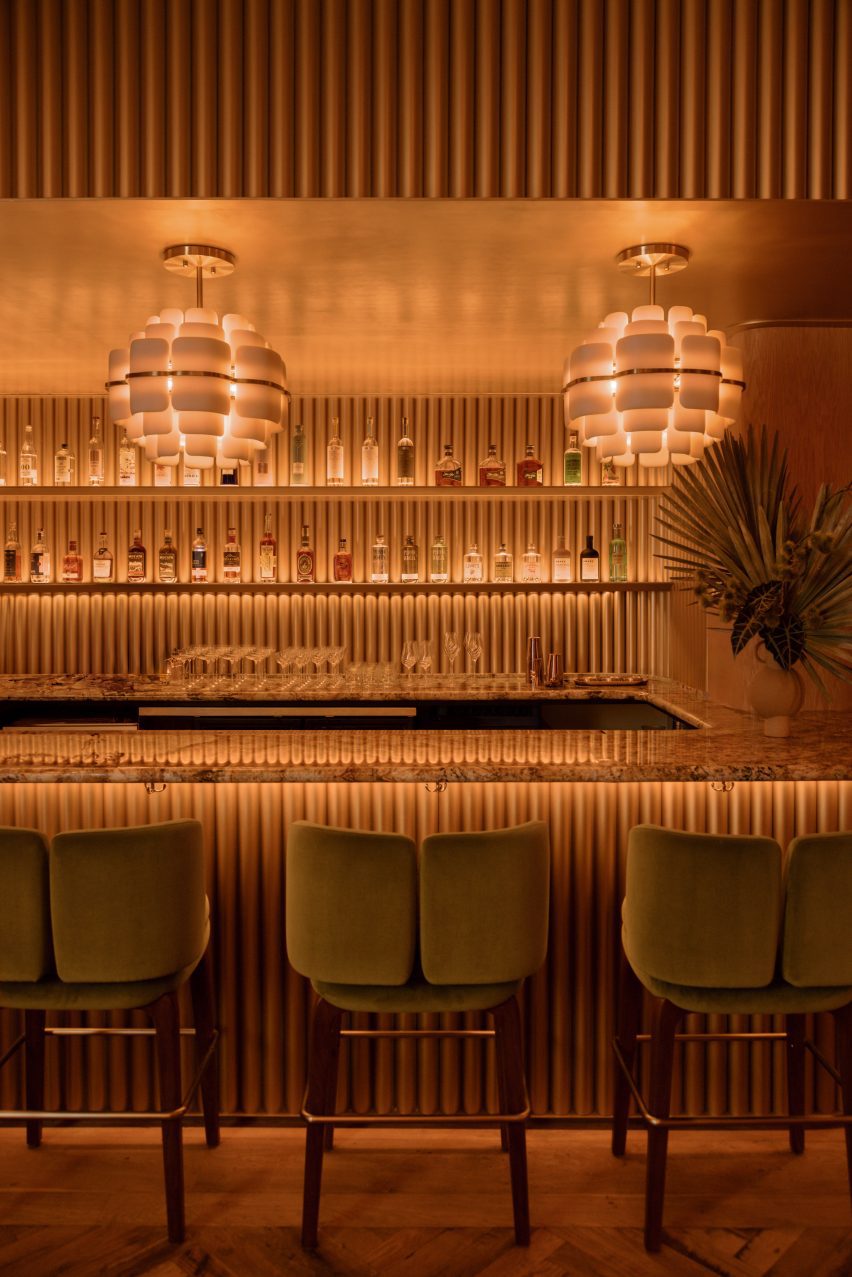 Back bar and counterfront featuring ribbed, golden surfaces