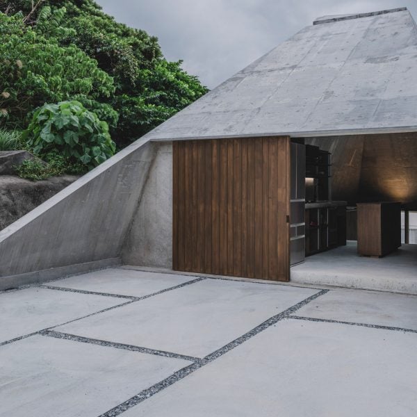 IGArchitects adds pyramidal concrete home to sloping site in Okinawa