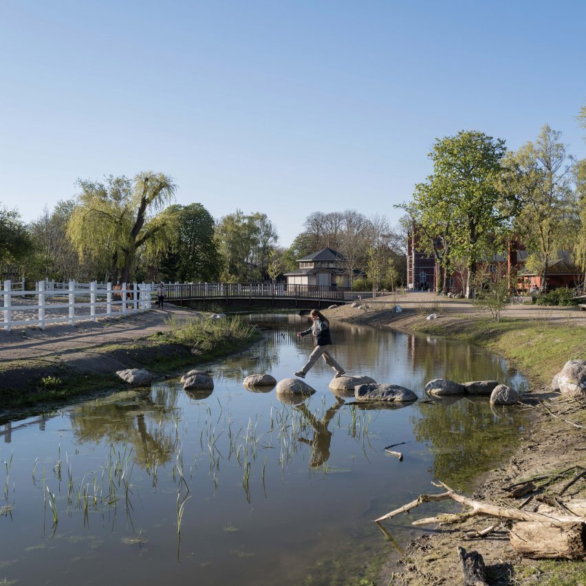 Person walking across pond within Karens Minde Axis park in Copenhagen