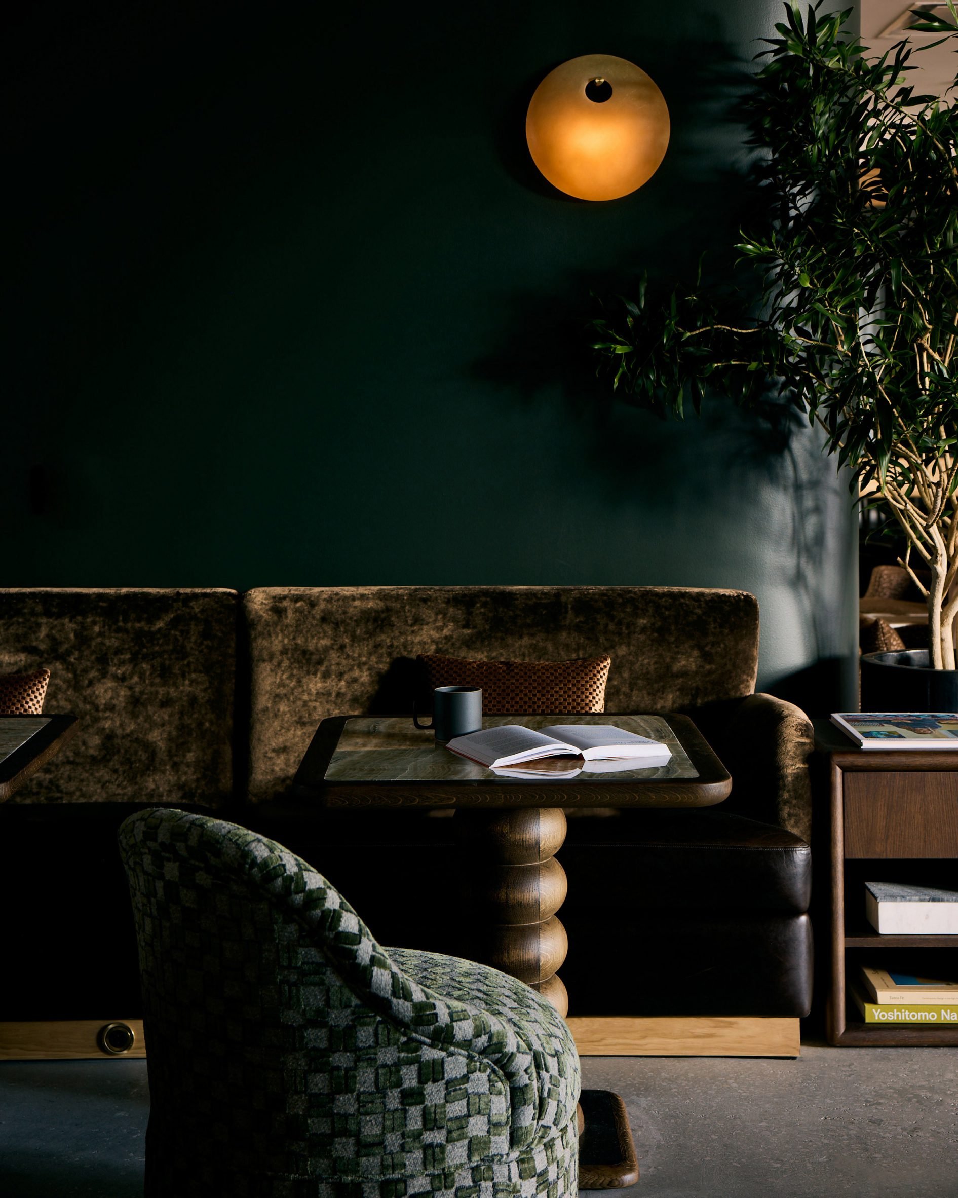 Textured banquette seat against a dark green wall