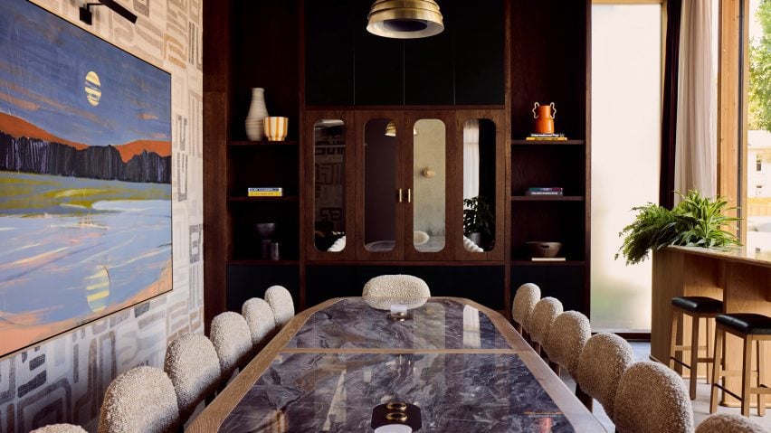 Boardroom with dark wood built-ins and a large marble-topped table