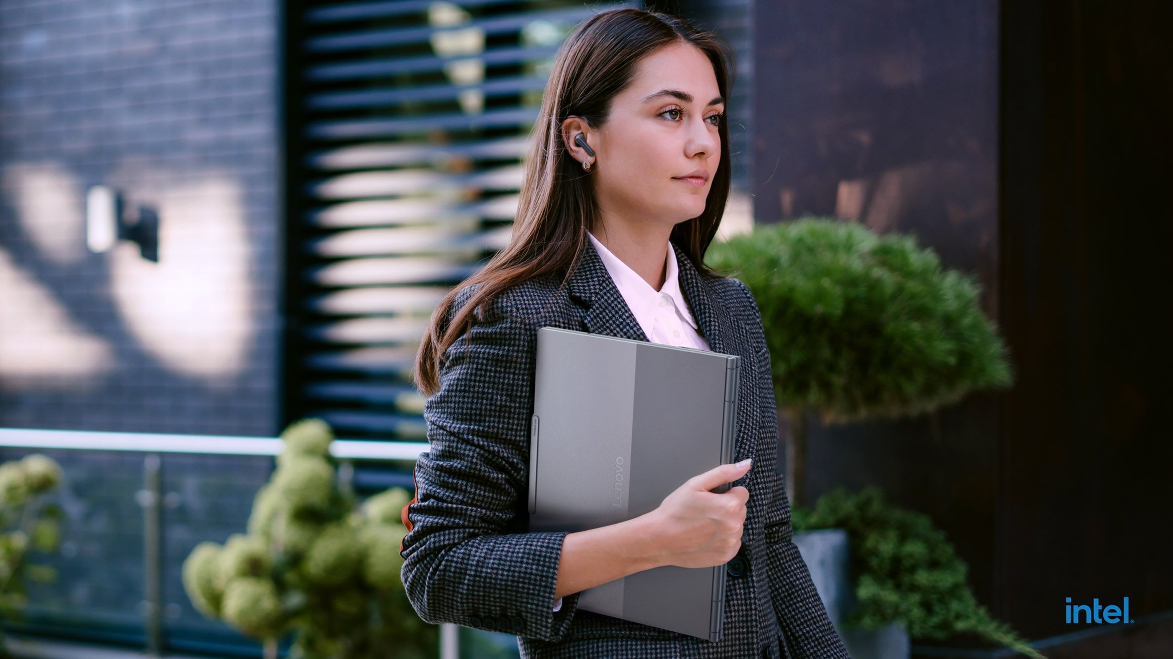 Woman carrying Lenovo's ThinkBook Plus Gen 6 Rollable