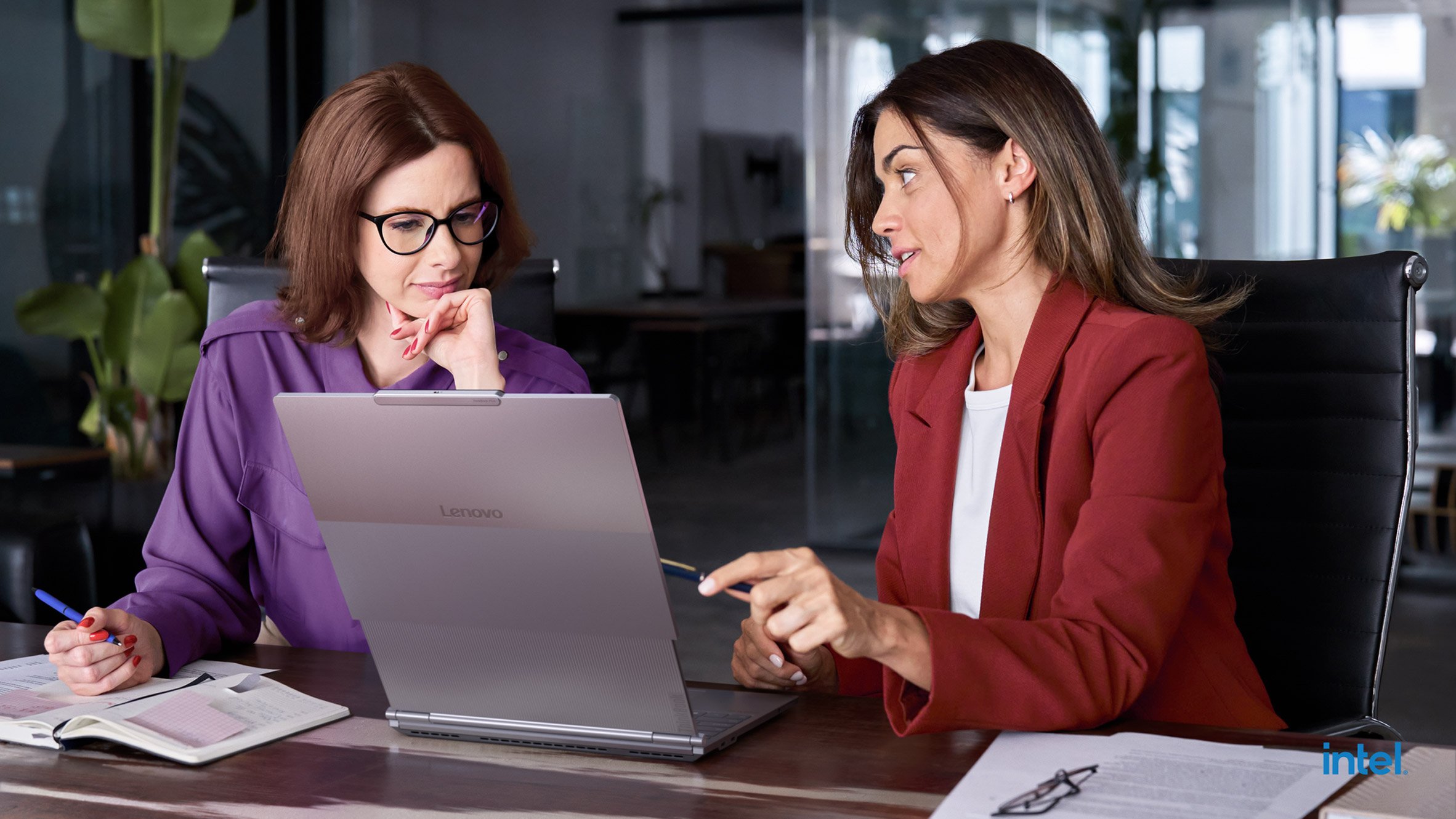 Two women using ThinkBook Plus Gen 6 Rollable in an office