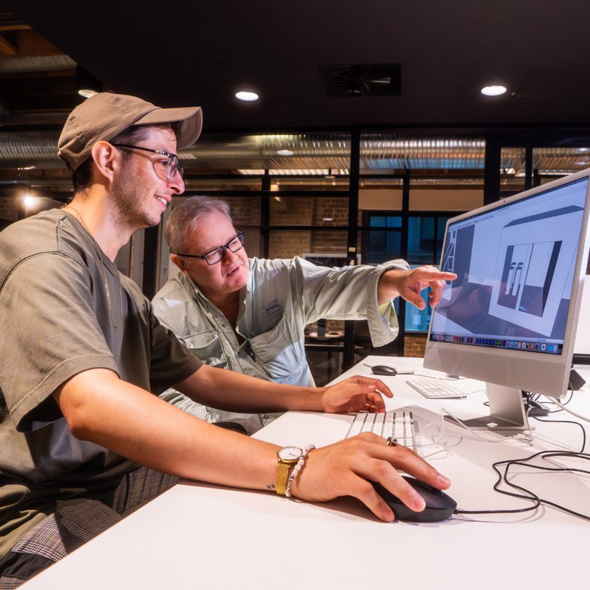 a photograph of students working together at a desk