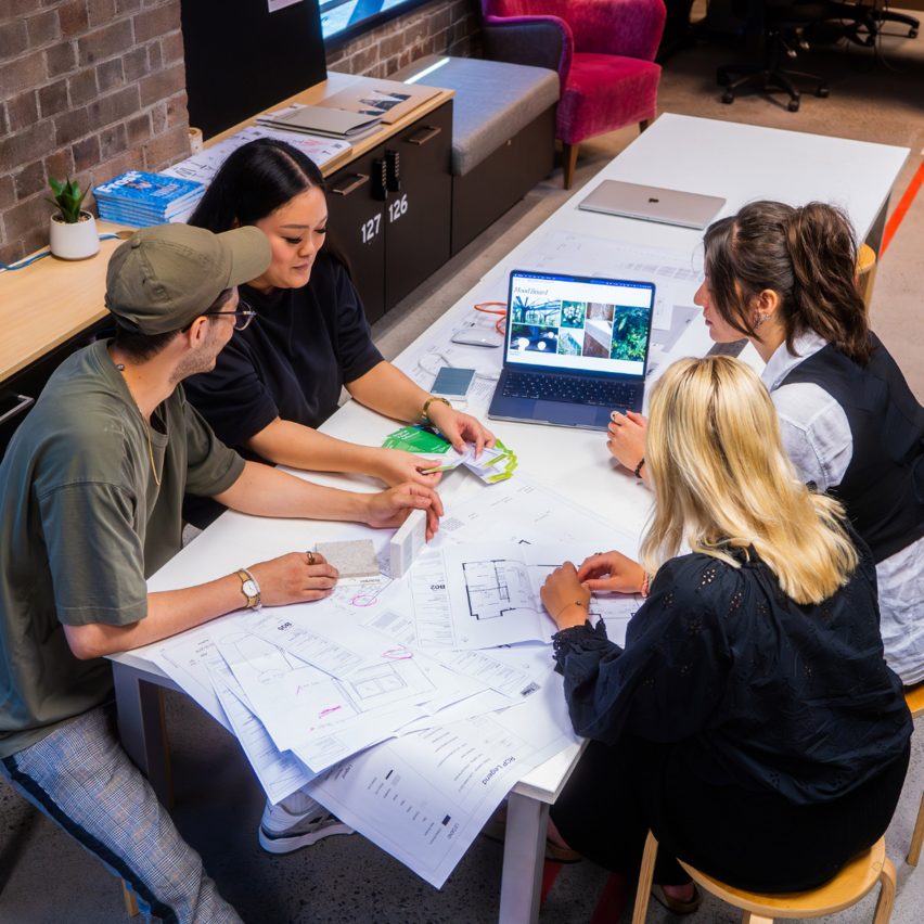 a photograph of students working together at a desk