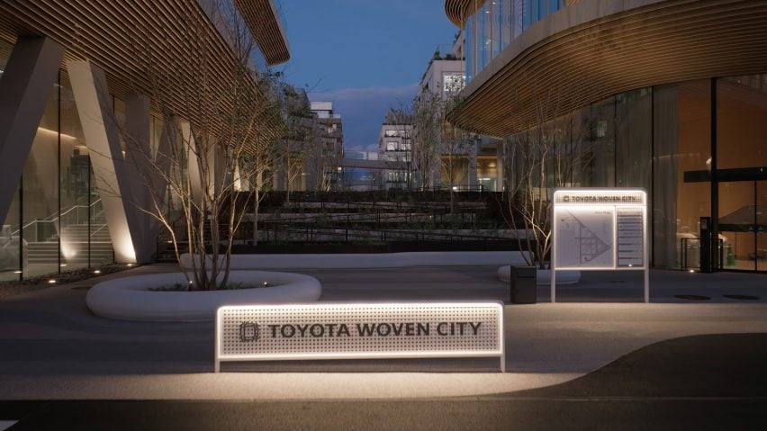 View of Woven City with street sign