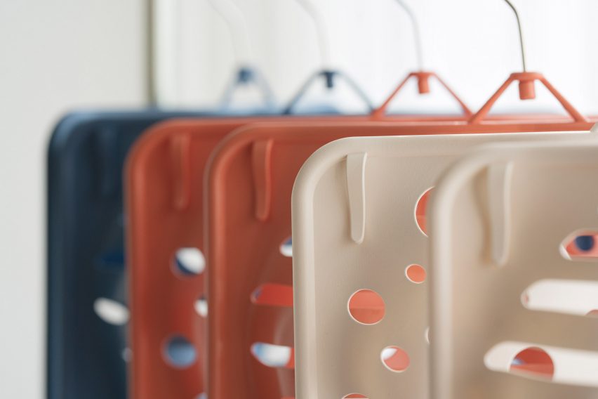 White, coral and blue Bras Up hangers hung up