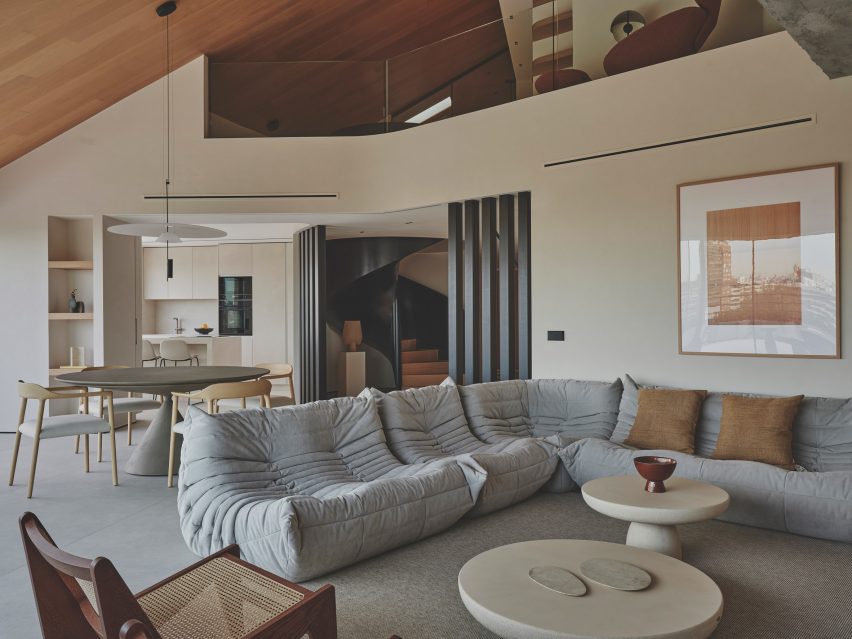 Photograph of a minimalist, open-plan interior focusing on a large seating area
