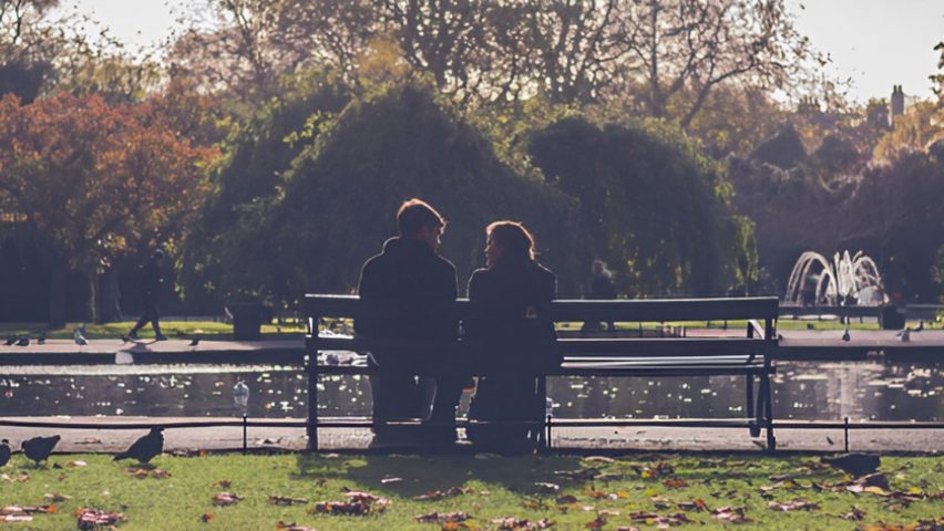 Two people sitting on a bench