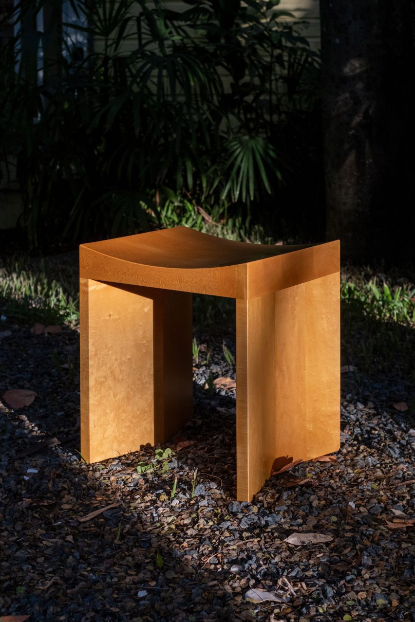 Light brown wooden chair by Juntos Projects placed outside