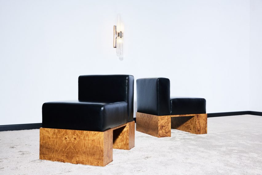 Photo of black leather chairs with wooden legs
