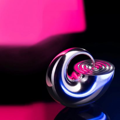 A photograph of a silver trophy in a circular abstract form, with pink and black lighting behind it.