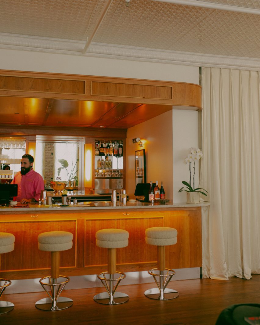 Wooden bar area next to floor-to-ceiling curtains