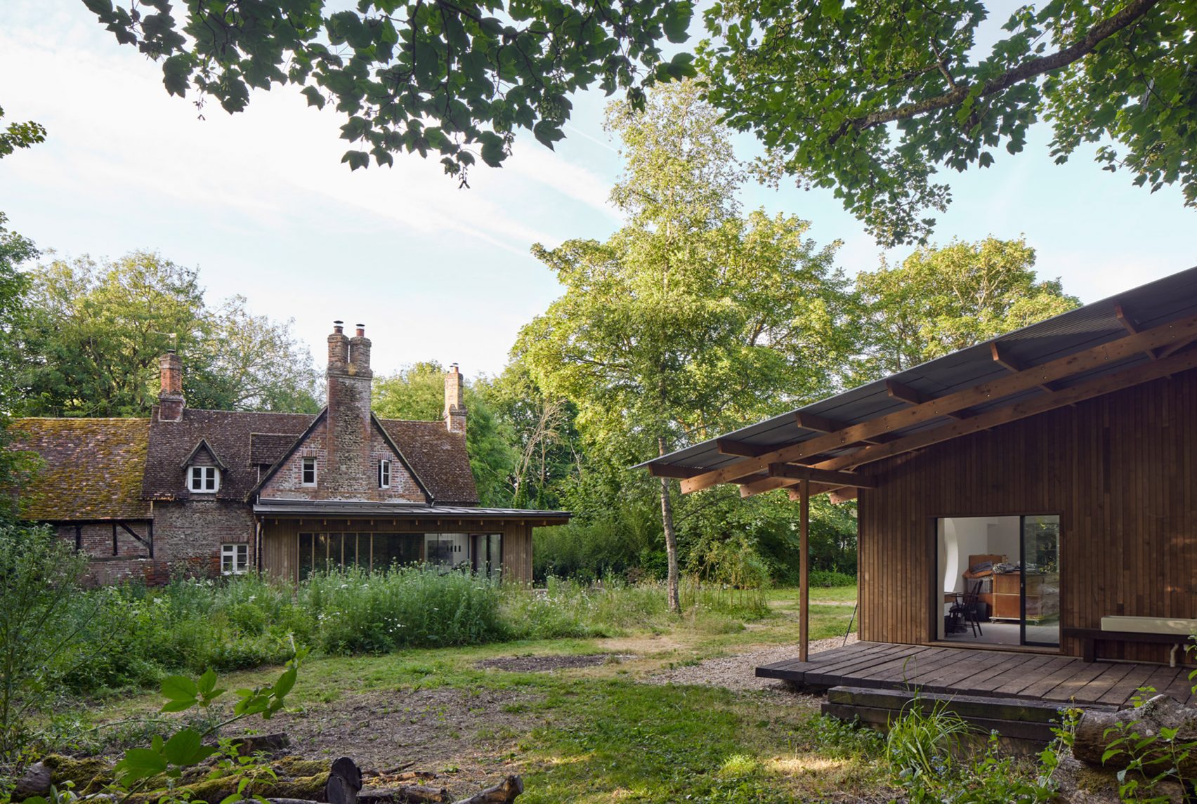 Cooke Fawcett adds timber-clad extensions to Hampshire mill house