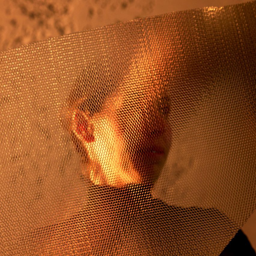 Close up of material with woman standing behind it