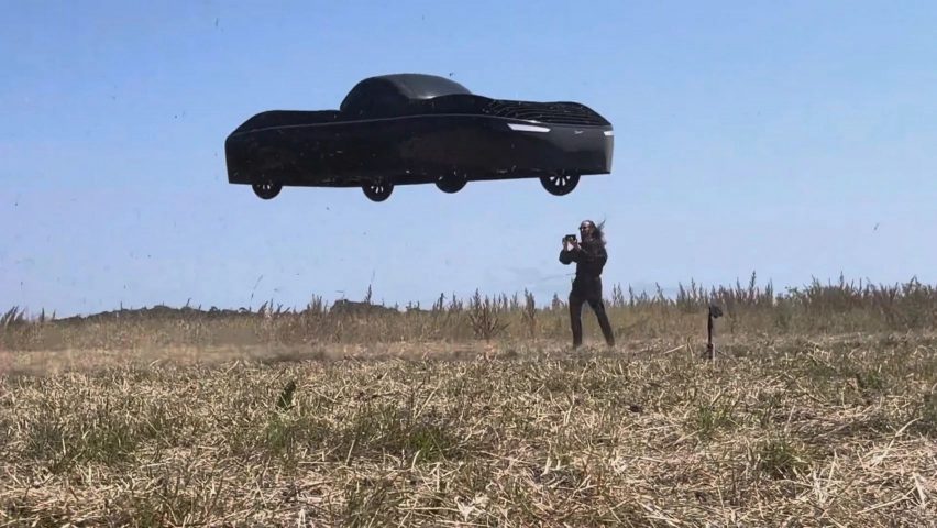 Flying car drone with man in field
