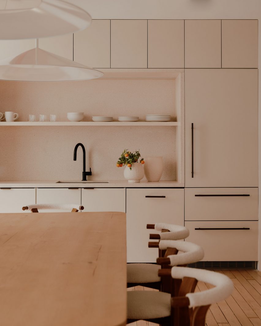 Kitchen with pale millwork and stone backsplash