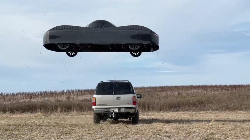 flying electric car hovering over another truck